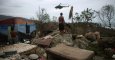 Un hombre observa un helicóptero en Cajobabo (Cuba) tras el paso del huracán Matthew. / ALEXANDRE MENEGHINI (REUTERS)